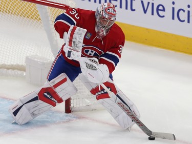 Montreal Canadiens goaltender Cayden Primeau plays the puck beside the crease
