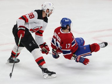 Canadiens' Josh Anderson loses his footing in front of Devils' Kevin Bahl