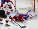 New Jersey Devils' Dougie Hamilton (7) comes up close and menacing on Montreal Canadiens goaltender Cayden Primeau during first period NHL action in Montreal on Tuesday Oct. 24, 2023.