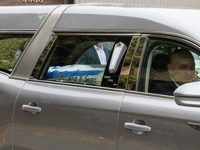 An Israeli flag covers the coffin carrying Alexandre Look's body in the hearse as it leaves the funeral home following service in Montreal on Thursday, Oct. 26, 2023.