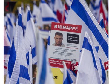 A sign with a picture of hostage Ron Scherman is held at a rally in Montreal on Sunday, October 29, 2023, organized by Federation CJA that called for the release of hostages being held by Hamas and other groups in Gaza.