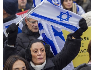 A woman holds a flag of Israel at a rally Sunday, Oct. 29, 2023, organized by Federation CJA that called for the release of hostages being held by Hamas and other groups in Gaza.