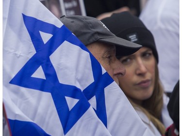 A man holds a flag of Israel at a rally in Montreal on Sunday, Oct. 29, 2023, organized by Federation CJA that called for the release of hostages being held by Hamas and other groups in Gaza.