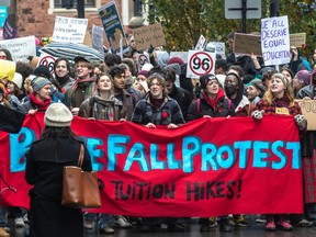 Students bearing banners protest planned tuition hikes in Montreal.