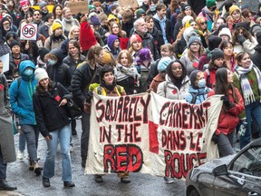 Students carry banners as they protest against tuition hikes in Montreal.