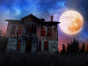 A giant full moon behind a creepy old house surrounded by trees and stars.