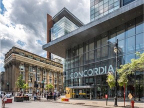 A Concordia sign can be seen in the base of a glass tower on a downtown street