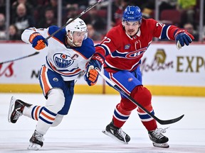 Connor McDavid (left) of the Edmonton Oilers and Arber Xhekaj of the Montreal Canadiens skate against each other.