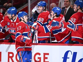 Canadiens' Sean Farrell skates past his team's bench to get glove taps from his teammates after scoring his first career NHL goal last season.