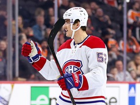 Defenceman Justin Barren seen in the Habs' away uniform pointing at a teammate.