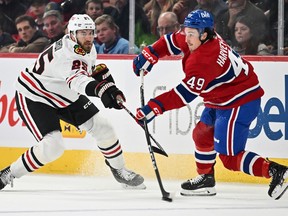 Jarred Tinordi (25) of the Chicago Blackhawks defends against Canadiens' Rafaël Harvey-Pinard at the Bell Centre on Saturday, Oct. 14, 2023, in Montreal.
