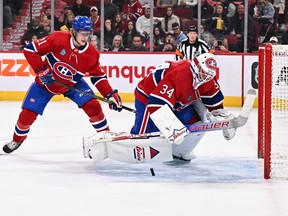 Canadiens goaltender Jake Allen spins around for the puck as teammate Kaiden Guhle watches during the first period against the Winnipeg Jets at the Bell Centre on Saturday, Oct. 28, 2023, in Montreal.