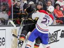 Canadiens defenceman Kaiden Guhle checks the Vegas Golden Knights’ William Karlsson into the boards during second period of Monday night’s game at T-Mobile Arena in Las Vegas.