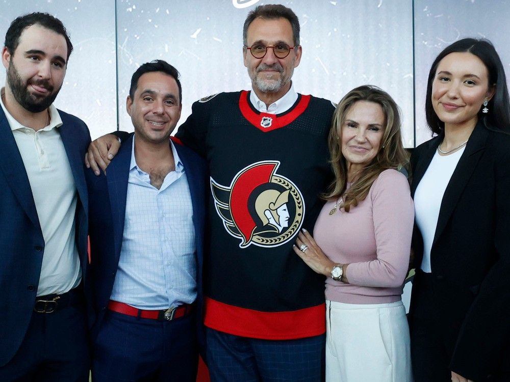 New Ottawa Senators owner Michael Andlauer, centre, poses with sons Michael and Matthew, wife Lucie and daughter Alexie after purchasing the team for US$950 million.