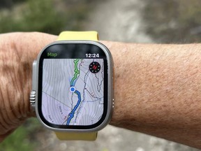 Jill Barker uses her smart watch during a hike in Invermere, B.C.