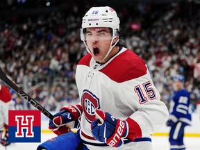A hockey player screams with joy after scoring a goal
