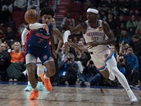 Oklahoma City Thunder's Shai Gilgeous-Alexander, right and Detroit Pistons' Killian Hayes (7) vie for the ball during first half NBA pre-season basketball action in Montreal on Thursday, Oct. 12, 2023.