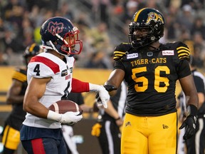 Hamilton Tiger-Cats' Ja'Gared Davis (56) shakes hands with Alouettes' Ciante Evans (4) who just made an interception during CFL action in Hamilton on June 23, 2023. Not only are the Alouettes (10-7) riding a four-game winning streak, they're attempting to reach 11 victories for the first time since 2012 when they play the Ticats at Molson Stadium on Saturday, Oct. 27, 2023.