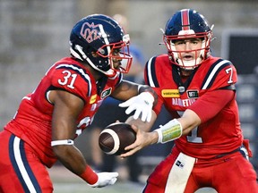 Alouettes quarterback Cody Fajardo hands off to running-back William Stanback during a game this year on Canada Day.