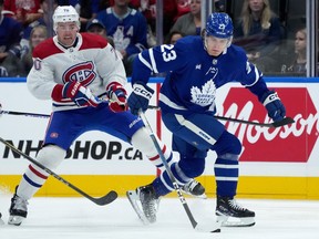 Leafs' Matthew Knies, in blue, is seen trying to pull away from Canadiens forward Tanner Pearson during pre-season game this month.