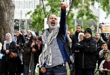 A man raises his fist to the sky during a protest