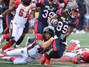 Alouettes' James Letcher Jr. (89) is tackled by Ottawa Redblacks' Anthony Gosselin (45) in Montreal on Oct. 9, 2023.