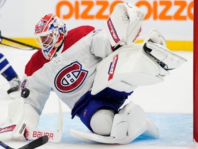 Canadiens goalie, in the team's white jersey, stacks the pads to make one of his 37 saves Wednesday night.