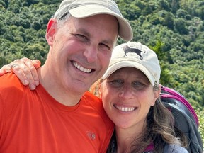 Shawna Goodman-Sone and her husband smile for the camera in a photo taken outdoors