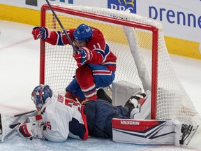 Canadiens' Brendan Gallagher is seen inside the Capital net behind the goalie with his arms raised after scoring a goal Saturday night at the Bell Centre.