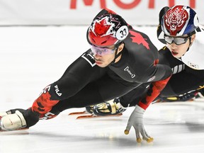 William Dandjinou (33) of Montreal takes a turn ahead of Park Ji Won of South Korea during the 1000-metre final race at the ISU World Cup Short Track Speedskating event in Montreal on Sunday, Oct. 22, 2023.
