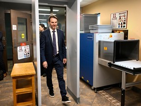 François Bonnardel walks through a metal detector
