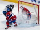 Canadiens goaltender Jake Allen makes a save against Jets' Alex Iafallo as Canadiens' Cole Caufield defends during first-period action at the Bell Centre Saturday night.