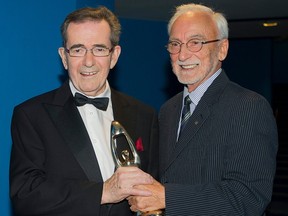 Guy Latraverse, left, holds up his honour award with a little help from Yvon Deschamps at the ADISQ awards gala in Montreal on Oct. 27, 2013. Latraverse died Saturday, Oct. 15, 2023, at the age of 84.