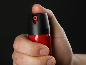 Stock image of a hand holding pepper spray