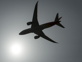 A plane is silhouetted as it takes off from Vancouver International Airport in Richmond, B.C., on May 13, 2019.