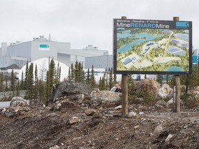 A large industrial building sits behind a sign identifying the Renard Mine
