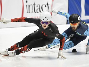 Félix Roussel of Sherbrooke, front, skates ahead of Denis Nikisha of Kazakhstan during the 500-metre quarter-final race at the ISU World Cup Short Track Speedskating event in Montreal on Sunday, Oct. 22, 2023.