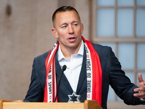 Mixed martial arts fighter Georges St-Pierre delivers remarks after receiving the Order of Sport during the Class of 2023 induction ceremony in Gatineau, Que., on Thursday, Oct. 19, 2023.