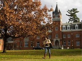 A student walks through the campus of Bishop's University in the fall.