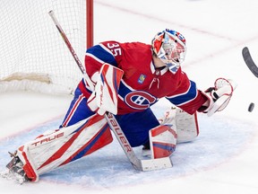 Canadiens goalie seen making a glove save with his left hand.
