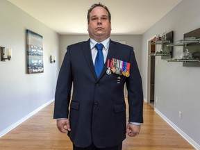 Canadian Forces veteran Ivan Beaudry wears his medals at his home in the Pierrefonds-Roxboro borough of Montreal.
