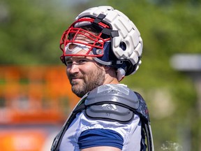 Veteran guard Kristian Matte is seen with his helmet up and smiling while taking a break from practice on a sunny day in May.