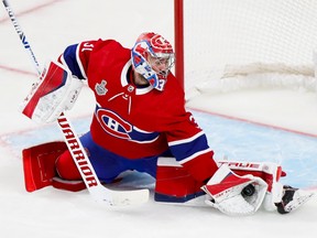 Carey Price is seen in a photo from 2021 making a glove save in front of his left pad at the Bell Centre.