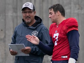 Aouettes offensive co-ordinator and quarterbacks coach Anthony Calvillo Alouettes speaks to QB Cody Fajardo during training camp this year.