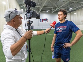 Reporter Zdenek Matejovsky holds the camera and microphone while interviewing Habs' top draft pick David Reinbacher during rookie camp.