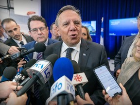 Quebec Premier François Legault is scrummed by reporters.