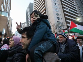 A youngster gestures as people take part in a demonstration in support of the Palestinian people in downtown Montreal on Oct. 10, 2023.