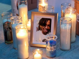 Candles surround a photo of 16-year-old Jannai Dopwell-Bailey at a vigil for him in Montreal, Friday Oct. 22, 2021.