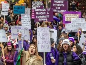 Students shout and hold placards at a demonstration in Montreal against Quebec's plan to double tuition fees for out-of-province students.