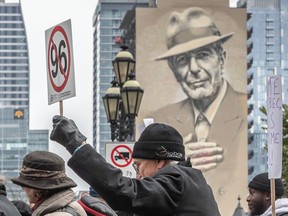 Demonstrators carry placards during a protest in Montreal against the CAQ government's planned tuition hikes for out-of-province students and other language policies.